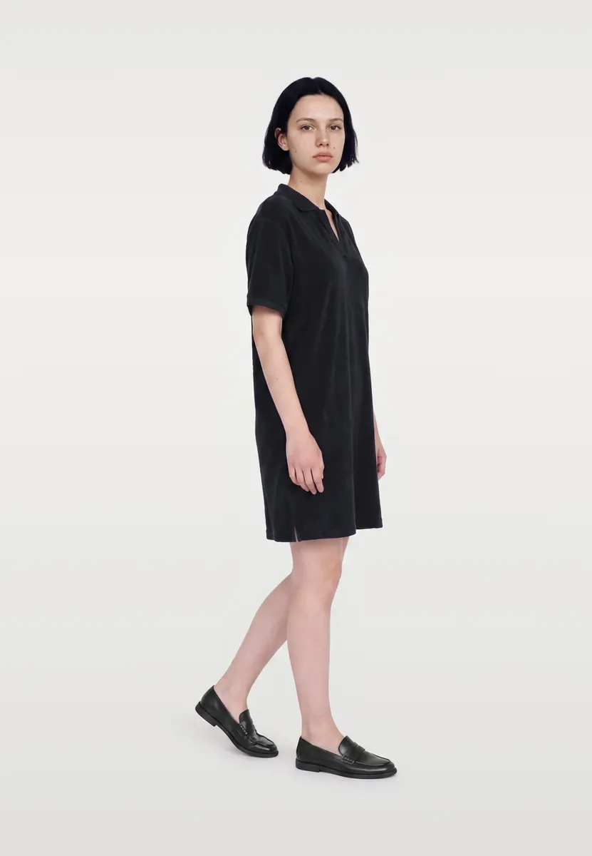 A dark blue polo dress worn full length